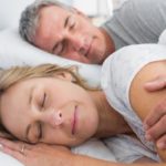 Couple happily sleeping, free of tmj and sleep apnea