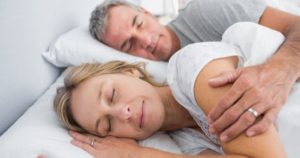 Couple happily sleeping, free of tmj and sleep apnea